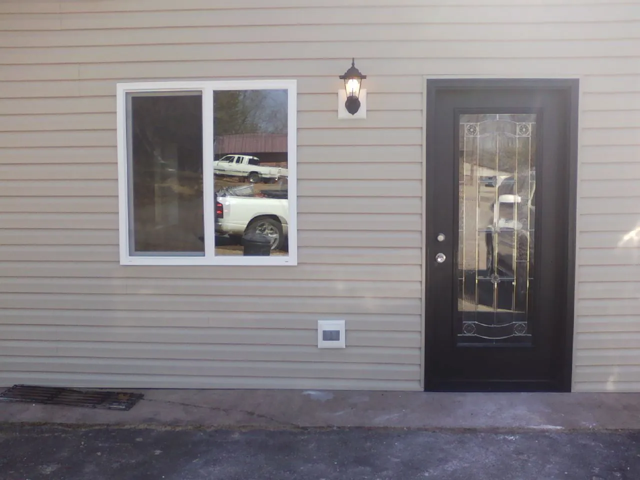 New siding, window and entry door on the side of an addition in Mount Hood Parkdale